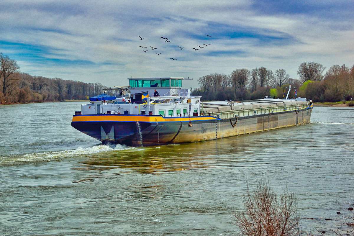 Fließgewässer als Wasserstraße: Frachtschiff auf einem Fluss, (c) Marion Wellmann/Pixabay